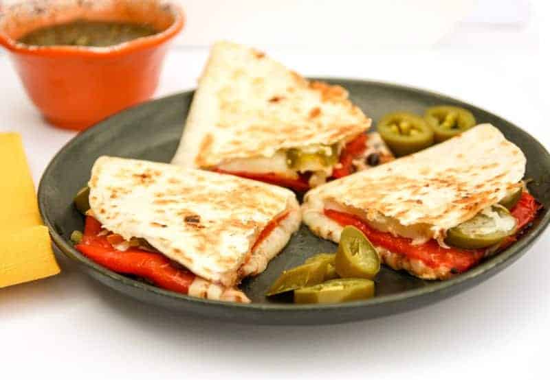 A plate of food on a table, with Quesadilla and Cheese