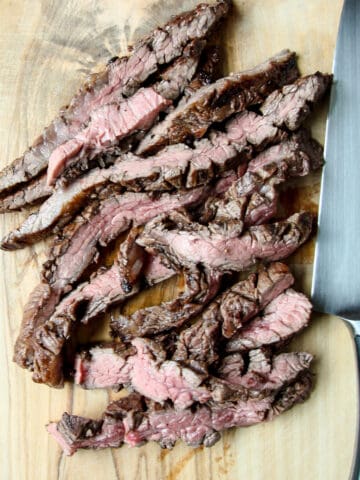 Slices of steak on a cutting board.