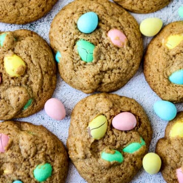 Mini egg cookies on a white surface.